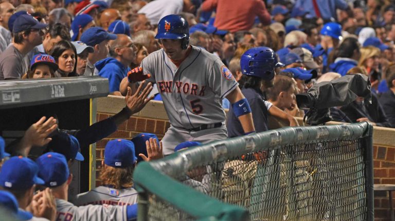 NLCS Game 3: Mets vs. Cubs 61 New York Mets third baseman David Wright (5) is high-fived in the dugout after he scored on a double by New York Mets centerfielder Yoenis Cespedes (52) in first inning during Game 3 of the NLCS against the Chicago Cubs at Wrigley Field on Tuesday, Oct. 20, 2015.