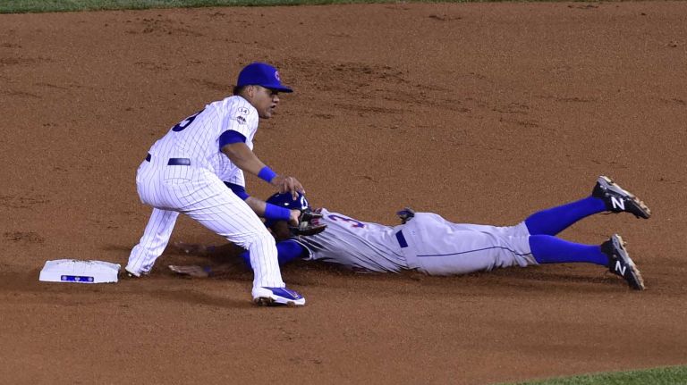 NLCS Game 3: Mets vs. Cubs 65 Chicago Cubs second baseman Starlin Castro (13) tags out New York Mets rightfielder Curtis Granderson (3) as he attempts to steal second base in the first inning during Game 3 of the NLCS against the Chicago Cubs at Wrigley Field on Tuesday, Oct. 20, 2015.