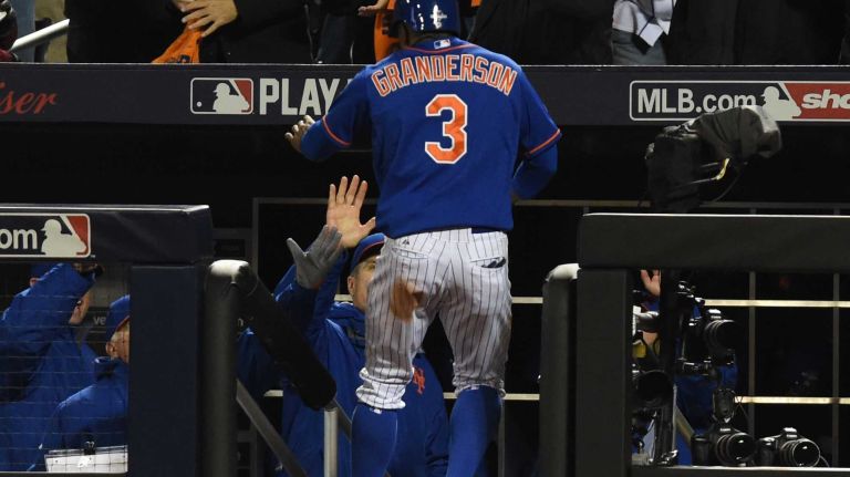 New York Mets right fielder Curtis Granderson (3) scores in the fourth inning during Game 2 of the NLCS against the Chicago Cubs at Citi Field on Sunday, Oct. 18, 2015.