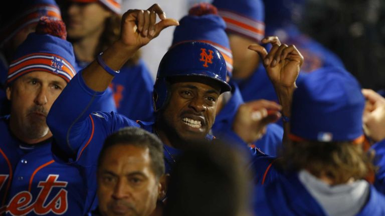 New York Mets right fielder Curtis Granderson (3) celebrates in the dugout after he scores on double by New York Mets third baseman David Wright (5) in first inning during Game 2 of the NLCS against the Chicago Cubs at Citi Field on Sunday, Oct. 18, 2015.