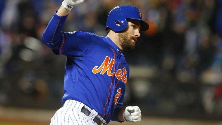 New York Mets second baseman Daniel Murphy (28) pumps his fist as he rounds 1st base after the 2 run homer in the first inning during Game 2 of the NLCS against the Chicago Cubs at Citi Field on Sunday, Oct. 18, 2015.