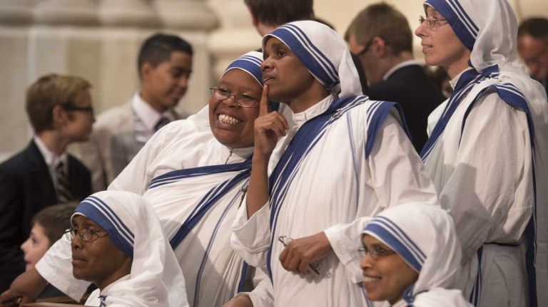The faithful await the arrival of Pope Francis for evening prayer services at St. Patrick's Cathedral in Manhattan on Thursday, Sept. 24, 2015.