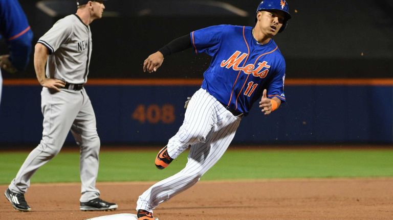Subway Series: Yankees vs. Mets 56 New York Mets shortstop Ruben Tejada rounds third base on his way to score on the RBI double by Mets third baseman David Wright during the first inning against the New York Yankees in a baseball game at Citi Field on Sunday, Sept. 20, 2015.