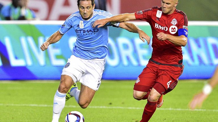New York City FC midfielder Frank Lampard battles for the ball with Toronto FC midfielder Michael Bradley in an MLS game at Yankee Stadium on Wednesday, Sept. 16, 2015.