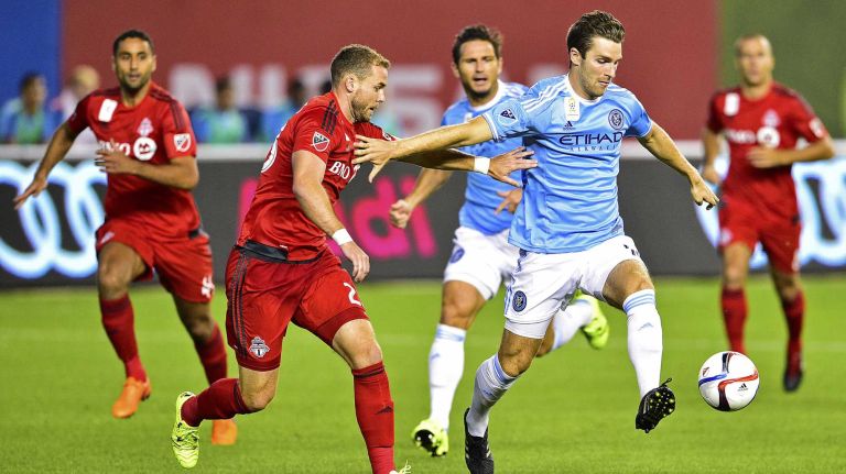 New York City FC forward Patrick Mullins is defended by Toronto FC defender Josh Williams in an MLS game at Yankee Stadium on Wednesday, Sept. 16, 2015.