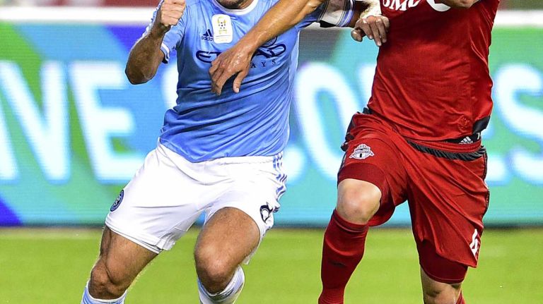 New York City FC midfielder Frank Lampard battles for the ball with Toronto FC midfielder Michael Bradley in an MLS game at Yankee Stadium on Wednesday, Sept. 16, 2015.