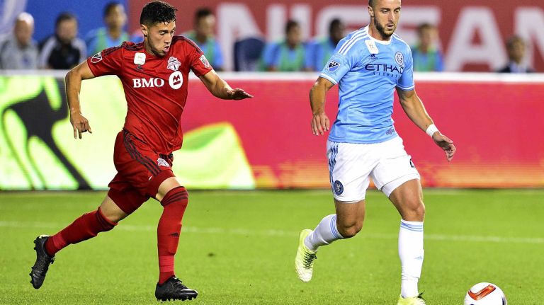 New York City FC defender RJ Allen is pursued by Toronto FC midfielder Jonathan Osorio in an MLS game at Yankee Stadium on Wednesday, Sept. 16, 2015.