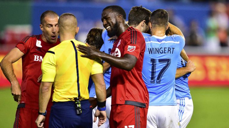 Toronto FC forward Jozy Altidore and midfielder Benoit Cheyrou argue with referee Chris Penso as New York City FC midfielder Frank Lampard is congratulated by his teammates after scoring a first-half goal in an MLS game at Yankee Stadium on Wednesday, Sept. 16, 2015.