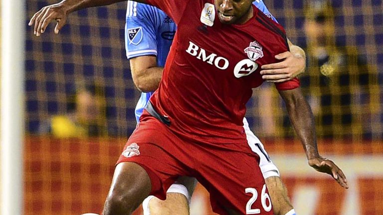 Toronto FC midfielder Collen Warner is defended by New York City FC forward Patrick Mullins in an MLS game at Yankee Stadium on Wednesday, Sept. 16, 2015.