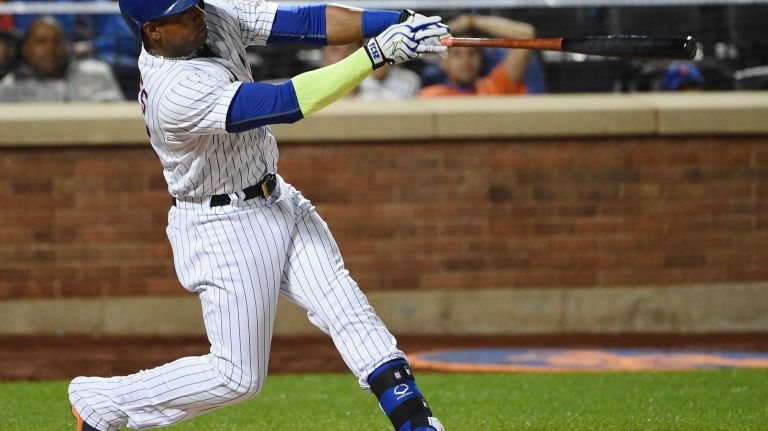New York Mets leftfielder Yoenis Cespedes hits a solo home run against the Miami Marlins during the third inning of a game at Citi Field on Monday, Sept. 14, 2015.