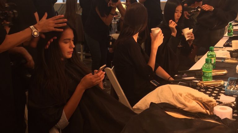 Models get ready backstage at the Elie Tahari Spring 2016 collection for New York Fashion Week on September 13, 2015. 