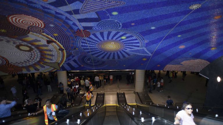 Passengers exit the 34th Street-Hudson Yards No. 7 station in Manhattan as service begins on Sunday, Sept. 13, 2015. The $2.42 billion, 1.5-mile extension of the No. 7 Line offers access to the Jacob Javits Convention Center, the High Line and Hudson River Park.