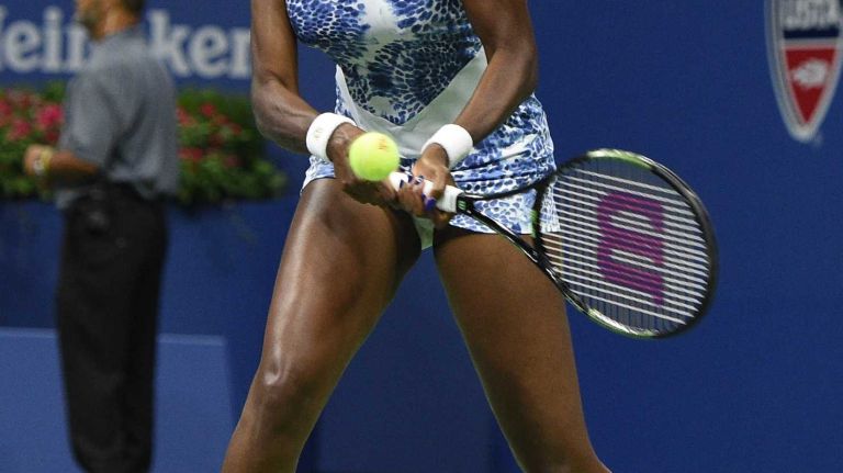 Venus Williams warms up against Serena Williams during the women's singles quarterfinals at the U.S. Open tennis tournament on Tuesday, Sept. 8, 2015.