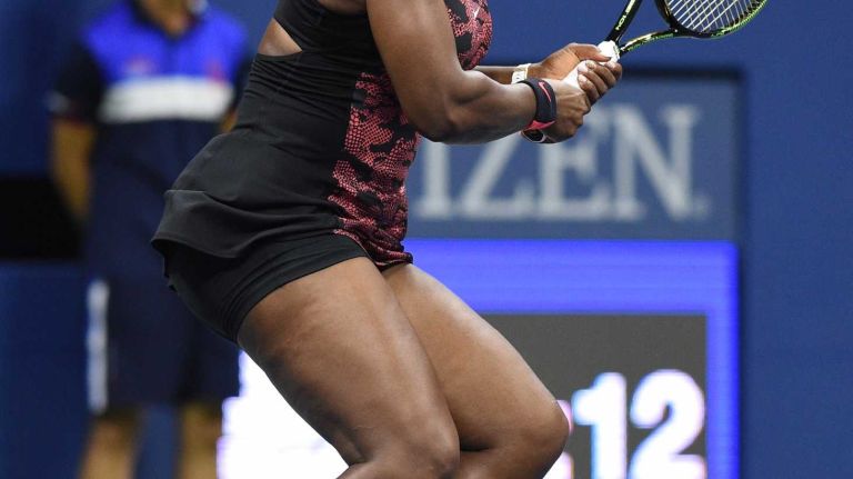 Serena Williams returns to Venus Williams during the women's singles quarterfinals at the U.S. Open tennis tournament on Tuesday, Sept. 8, 2015.