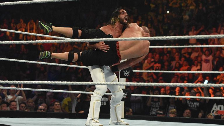 WWE world heavyweight champion Seth Rollins lifts U.S. champion John Cena to throw him to the mat during the Title vs. Title match at the WWE SummerSlam 2015 at Barclays Center on Sunday, Aug. 23, 2015.