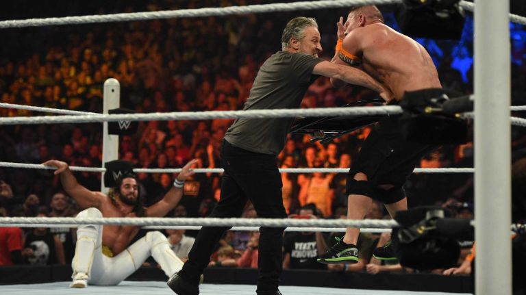 Jon Stewart hits United States Champion John Cena with a chair during the Title vs. Title match against WWE World Heavyweight Champion Seth Rollins during the SummerSlam 2015 at Barclays Center on Sunday, August 23, 2015.