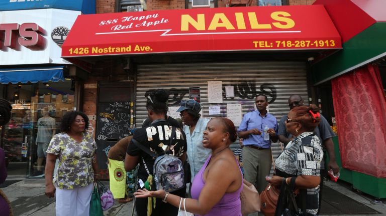 Protestors gather outside of a nail salon at 1426 Nostrand Ave. to collect petition signatures after last week's brawl at 888 Happy Red Apple Nails.
