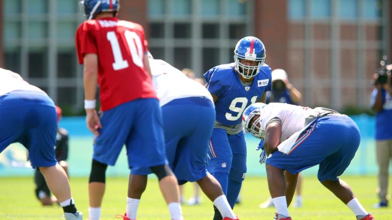 Giants defensive lineman Robert Ayers Jr. gets a read on quarterback Eli Manning during training camp at the Quest Diagnostics Training Center in East Rutherford, New Jersey, on Friday, July 31, 2015.