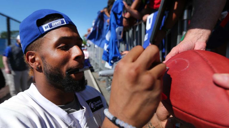 Giants wide receiver Odell Beckham Jr. signs autographs for fans after practice during training camp at the Quest Diagnostics Training Center in East Rutherford, New Jersey, on Friday, July 31, 2015.