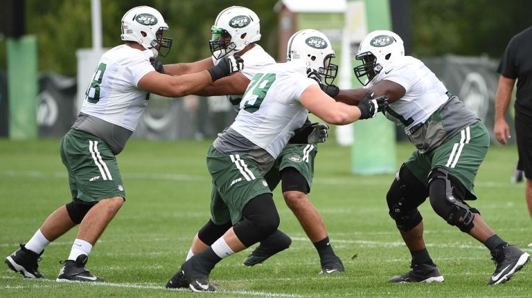 New York Jets tackle Brent Qvale (79) and tackle Ben Ijalana (71) practice drills at the Jets' Atlantic Health Training Center on Monday, August 10, 2015 in Florham Park, N.J.