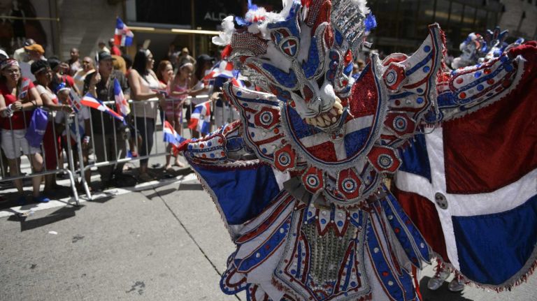 Participants march along Sixth Avenue during the 34rd annual Dominican Day Parade in Manhattan on Sunday, August 09, 2015. The Dominican Day Parade promotes the richness of the culture, folklore and popular traditions of the Dominican Republic.
