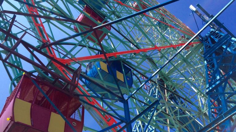 The swinging cars of the Wonder Wheel, painted red and yellow or blue and yellow, as seen on July 20, 2015. 