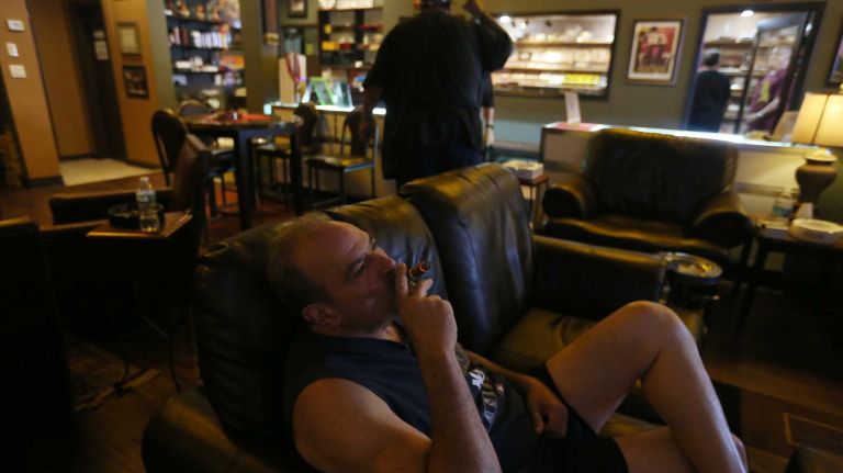 Gary G. smokes cigars at Carmine's Cigars, at 1671 Richmond Rd. in Dongan Hills, Staten Island, Saturday, July 25, 2015.
