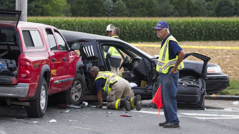 Officials work the scene on Route 48 and Depot Lane in Cutchogue, where a first responder said there were reports that a crash between a limousine and a pickup truck resulted in multiple fatalities on Saturday, July 18, 2015, a source said. 