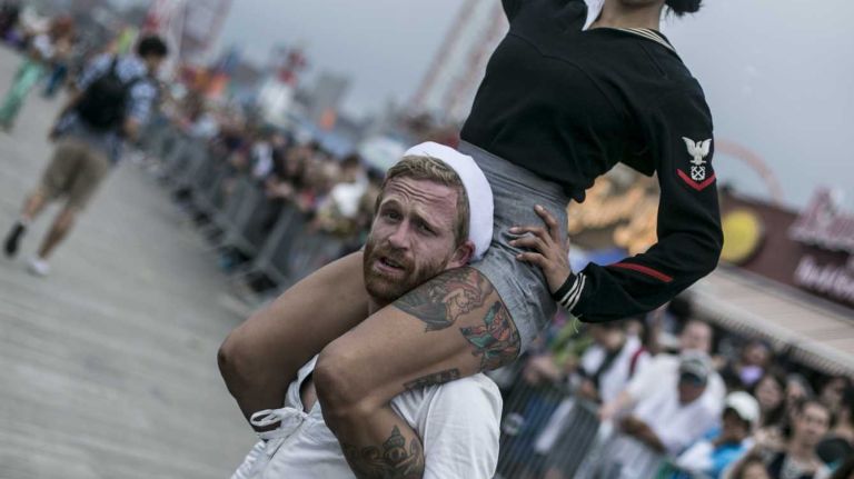 2015 Coney Island Mermaid Parade photos 29 Marchers salute at the Mermaid Parade in Coney Island on June 20, 2015.