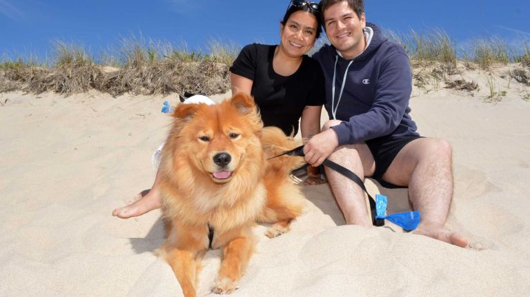Nicole Saldana and John Todd, with their rescue dog, hang out at Main Beach in East Hampton on Sunday, June 7, 2015.