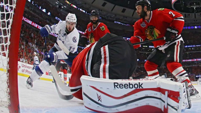CHICAGO, IL - JUNE 10: Corey Crawford #50 of the Chicago Blackhawks makes a save against Cedric Paquette #13 of the Tampa Bay Lightning during Game Four of the 2015 NHL Stanley Cup Final at the United Center on June 10, 2015 in Chicago, Illinois. (Photo by Bruce Bennett/Getty Images)