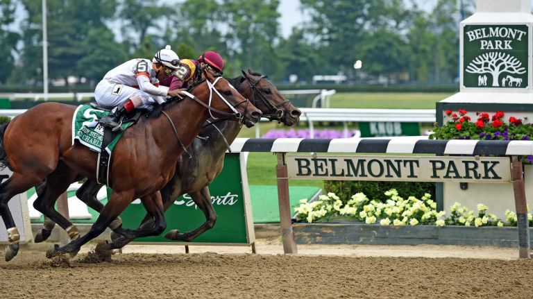 Race horses #2 March and #5 Cinco Charlie fight for the lead in the third race at Belmont Park on the afternoon of the Belmont Stakes, Jun3 6, 2015. #2 March won the race.