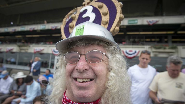 Dino MacDonald of Catharines, Canada, sports a triple crown hours before the race where Triple Crown challenger American Pharoah was looking to make history at Belmont Park Race Track in Elmont Saturday, June 6, 2015.