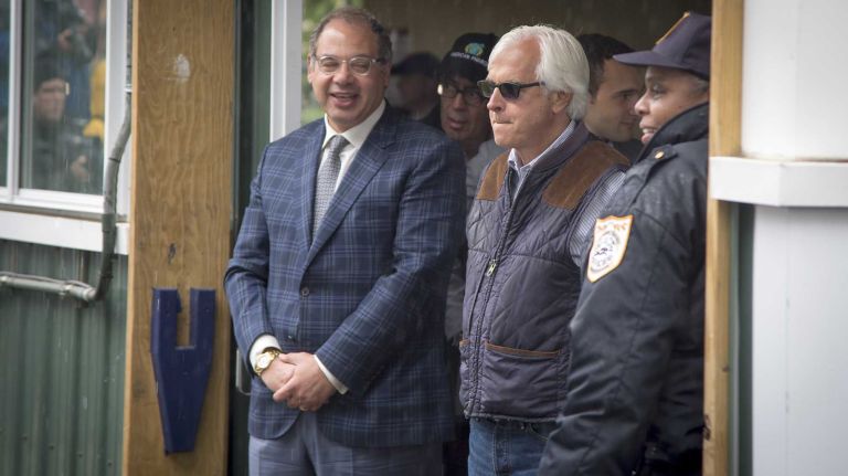 Trainer Bob Baffert stands next to Ahmed Zayat, owner of Triple Crown challenger American Pharoah, as they wait forthe horse to disembark from the horse van at Barn 1 at Belmont Park Race Track in Elmont on June 2, 2015.
