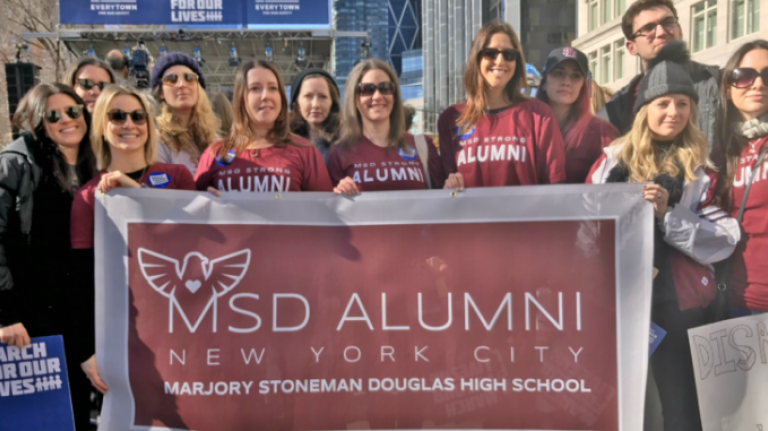 Marjory Stoneman Douglas High School alumni participate in New York City's March for Our Lives on Saturday.
