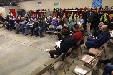 People wait for a caucus in a fire station in Kellogg