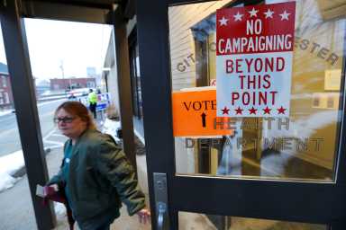 A voter leaves a voting location after casting her ballot in the New Hampshire U.S. presidential primary election in Manchester