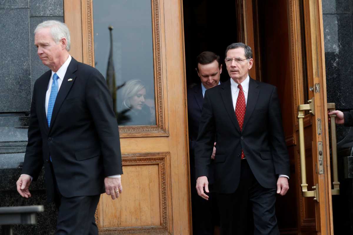 U.S. Senators Ron Johnson, John Barrasso and Chris Murphy leave the presidential office building in Kiev