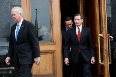 U.S. Senators Ron Johnson, John Barrasso and Chris Murphy leave the presidential office building in Kiev