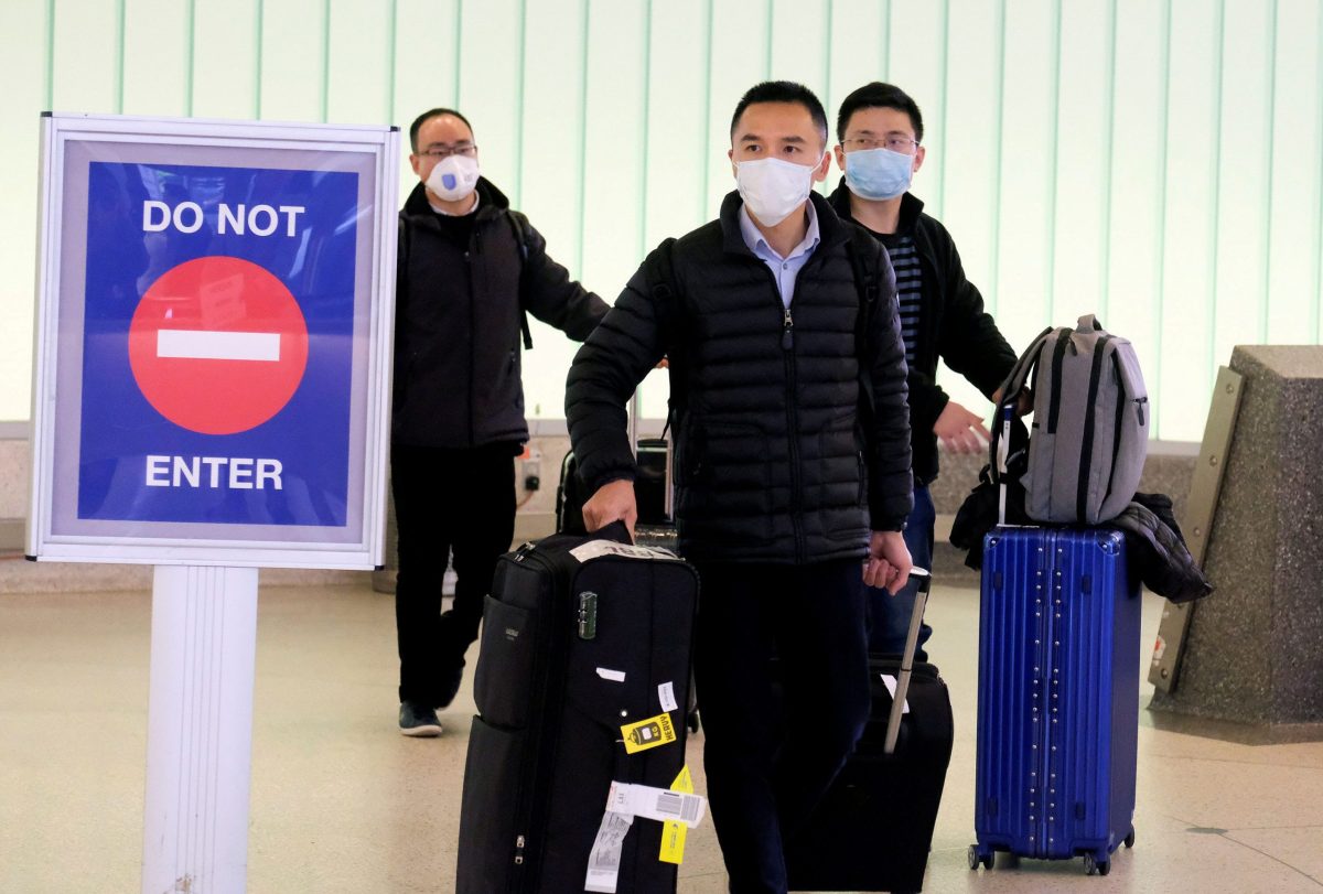 FILE PHOTO: Passengers arrive at LAX from Shanghai, China