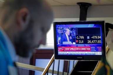 Traders work on the floor at the NYSE in New York