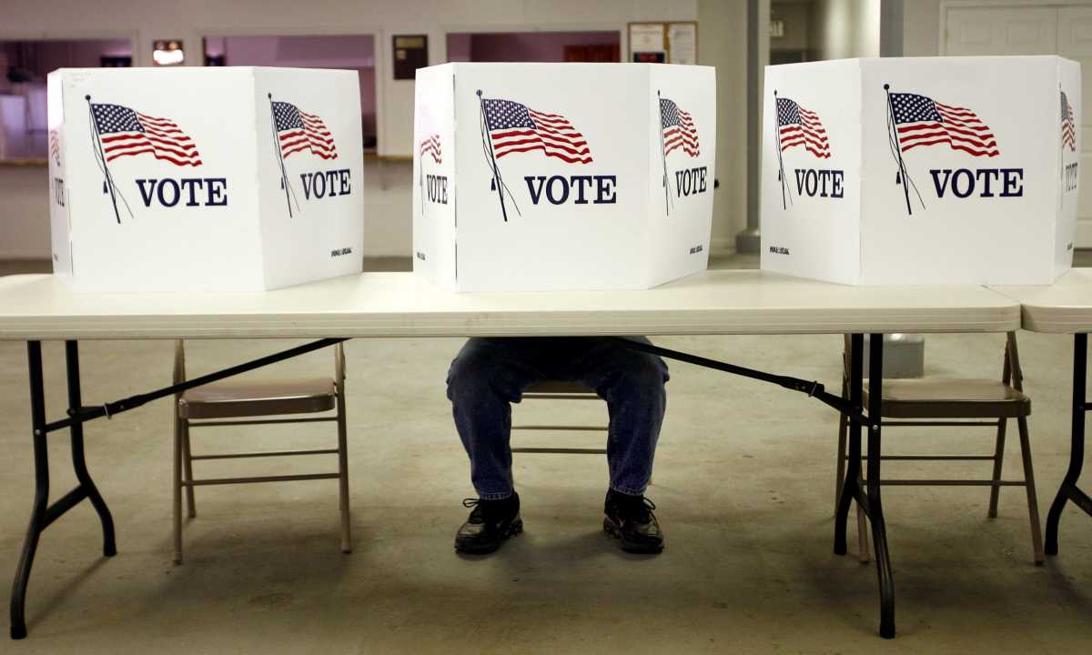 A voter casts a ballot at the Flushing Volunteer Fire Department in Flushing