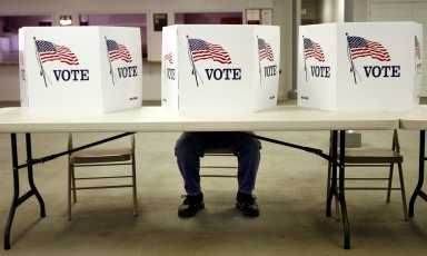 A voter casts a ballot at the Flushing Volunteer Fire Department in Flushing