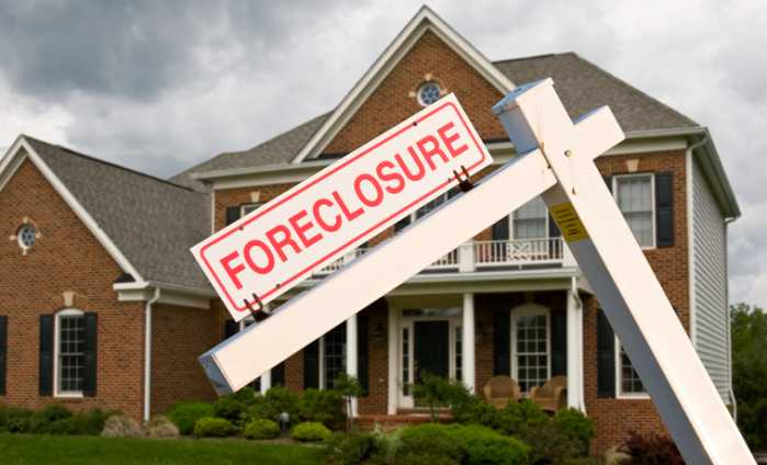 Foreclosure sign in front on modern house