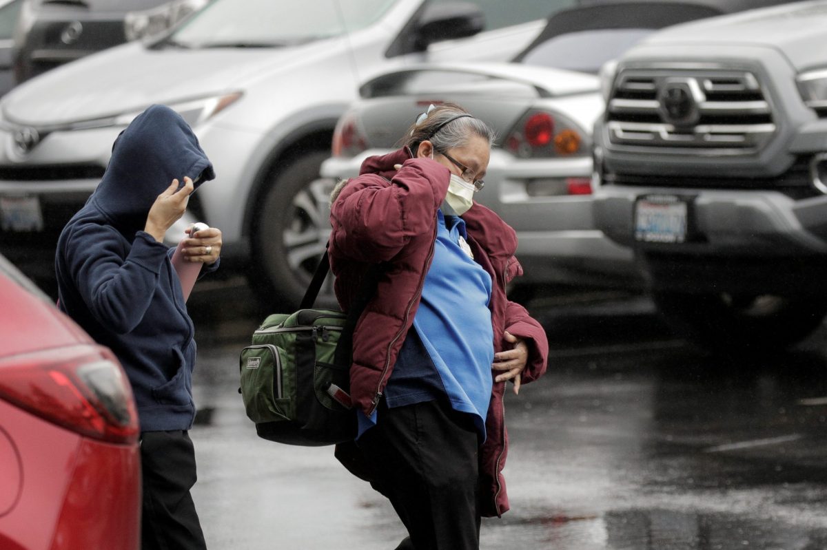 People are seen at the Life Care Center of Kirkland, the long-term care facility linked to several confirmed coronavirus cases, in Kirkland
