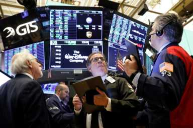 Traders work on the floor at the NYSE in New York