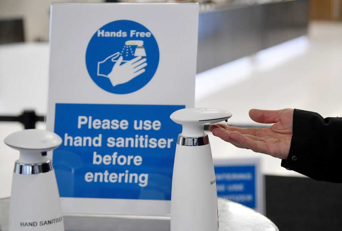 A visitor uses a hand sanitiser during the annual conference of the British Chambers of Commerce in London