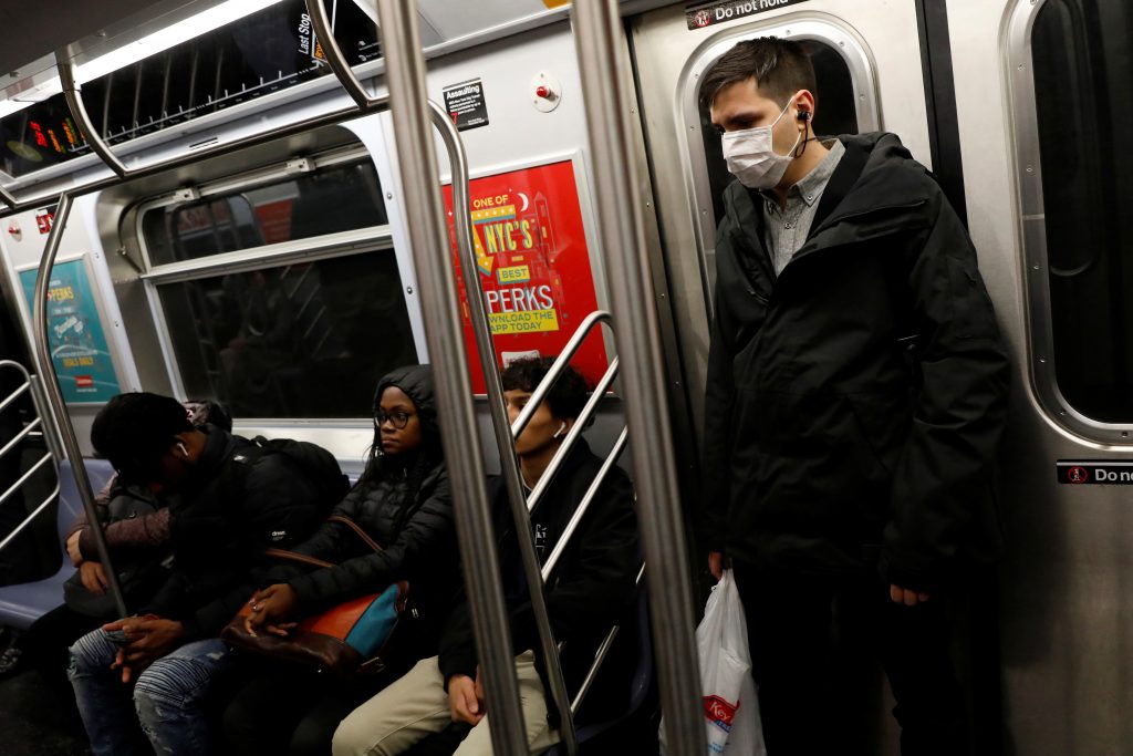 A man in a face mask rides the subway in Manhattan, New York City, after further cases of coronavirus were confirmed in New York