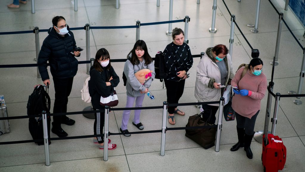 FILE PHOTO: People wait in line to reach TSA immigration process at the John F. Kennedy International Airport in New York