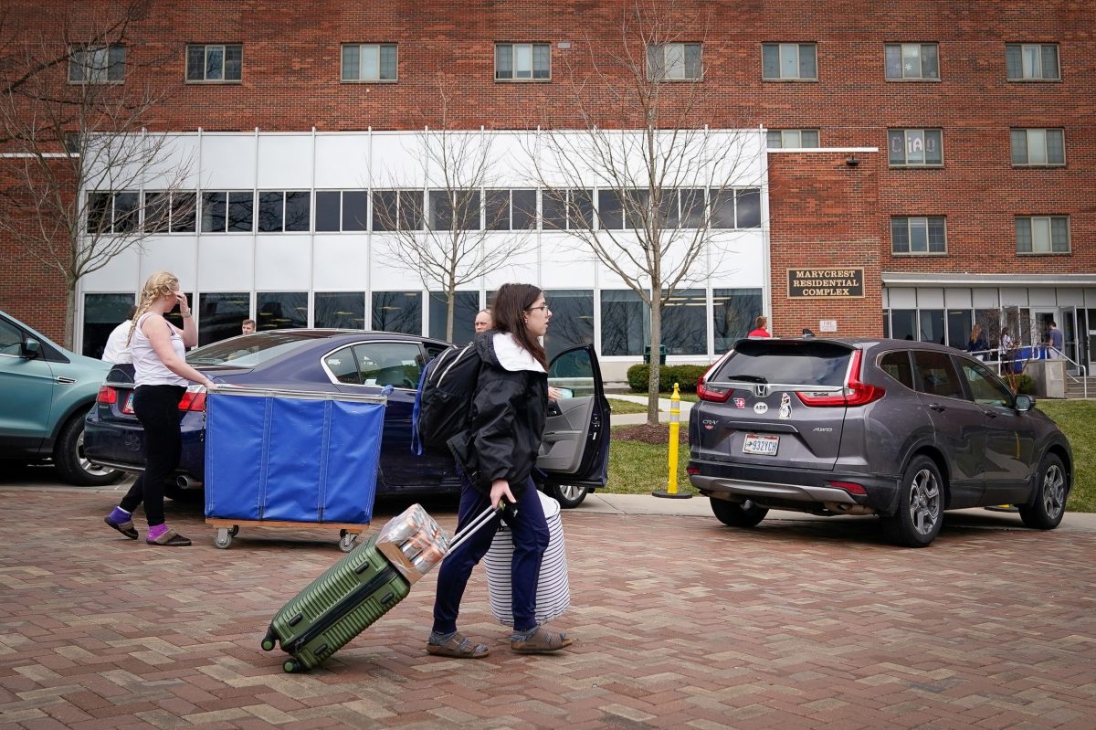 Students and their families load cars before a deadline to vacate University of Dayton in Ohio on-campus housing